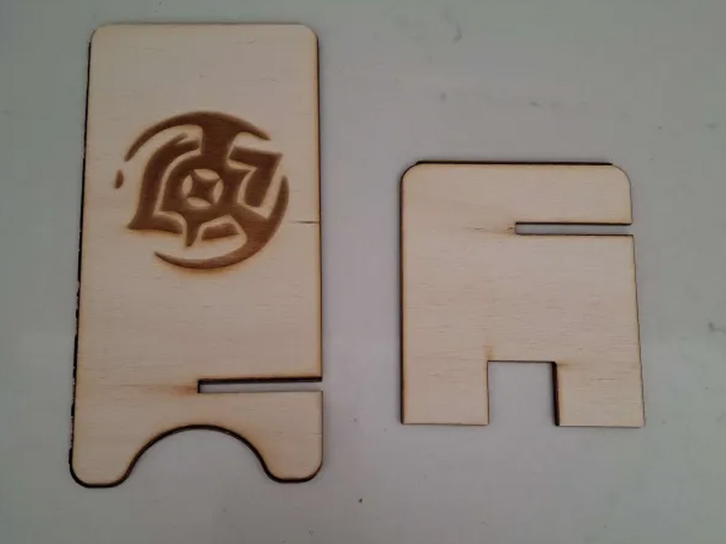 This is an image of my phone holder disassembled. I didn't expiriment with the different kinds of cuts the machine could do so its mostly just the engraved for the whole design.