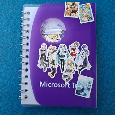 This is a small notebook that I chose to model since it has a unique design for its cover. The purple cover wrapers around the bottom and ends where a pen can be hung to hold it in place, and theres a clear cover behind it to protect the paper